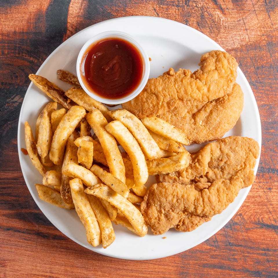 A white plate holds crispy fried chicken tenders, golden french fries, and a side of barbecue sauce.